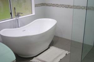 free standing bath in tiled bathroom
