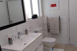 crisp white bathroom with white tiles