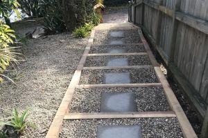 New paved and pebbled sleeper steps leading down to carport