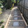 New paved and pebbled sleeper steps leading down to carport