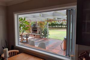 Installation of new double glazed aluminium bi-fold window to outdoor bar area and deck.