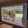 Installation of new double glazed aluminium bi-fold window to outdoor bar area and deck.