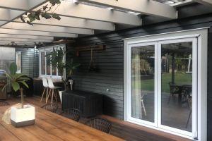 Installation of new double glazed aluminium bi-fold window and door joinery to deck .