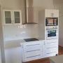 New reconfigured kitchen with tiled splashback and pantry in behind kitchen whangarei