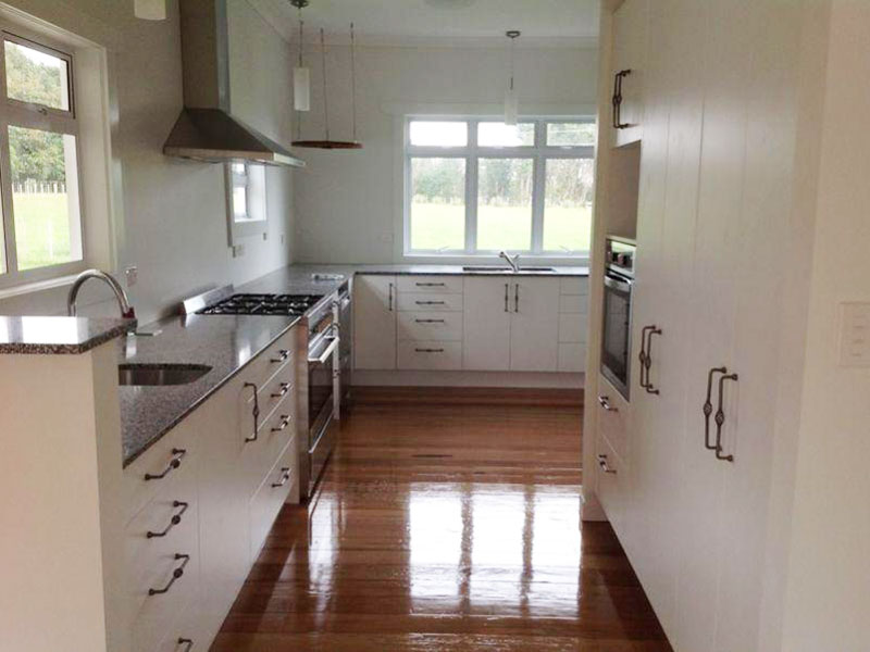 Large modern kitchen with timber flooring.