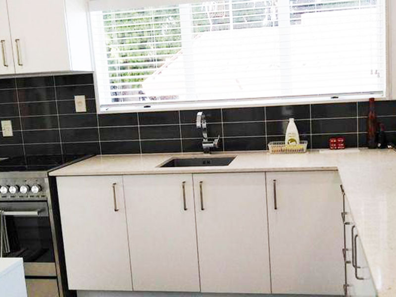 New fresh white kitchen to replace original timber kitchen. A new stone benchtop completes the smart fresh look.