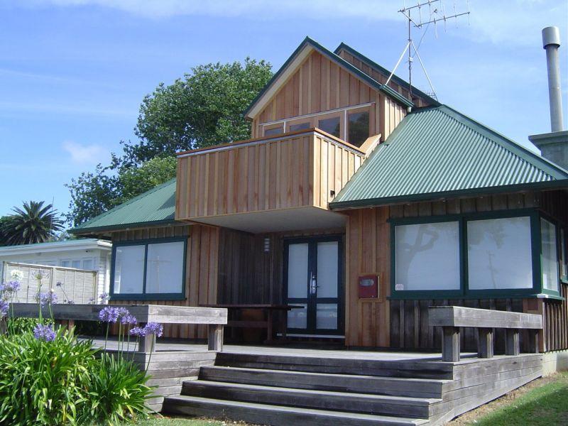 Replacement of existing cedar board and batten to front of house. Repairs to internal deck on the first floor.