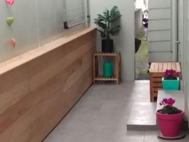 Tiled area with blockwork concealed by timber.